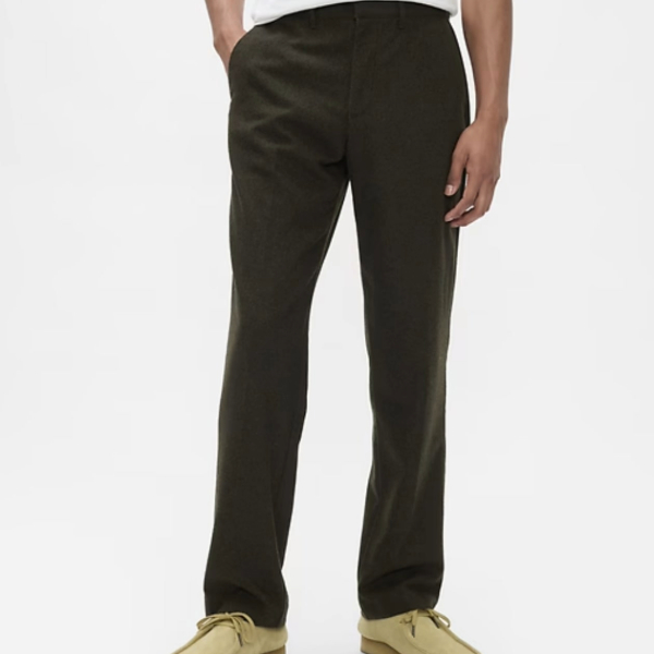 a man wearing relaxed fit trousers over suede boots