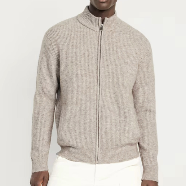 a man wearing a stitch zip front long sleeve shirt over casual pants