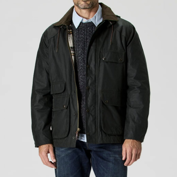man wearing a waxed jacket over a sweater and collared shirt and pants