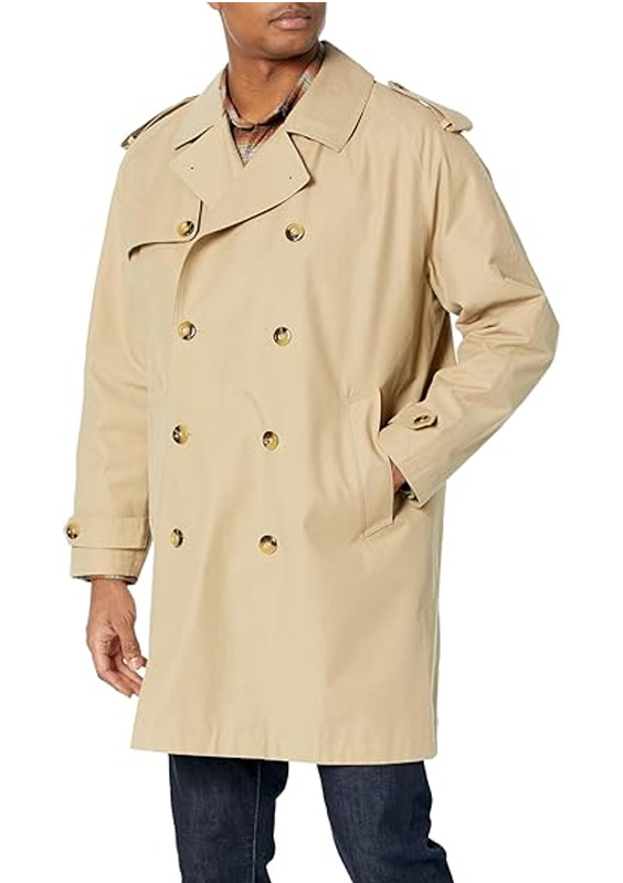 a man wearing a trench coat and denim jeans