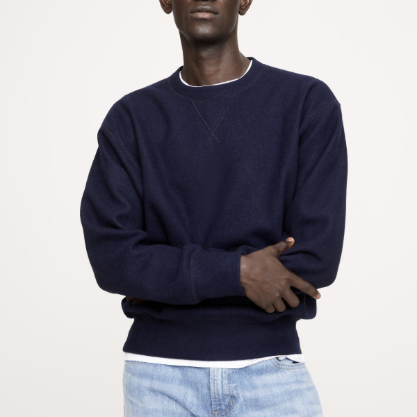 man wearing a brushed wool crew nech sweatshirt over denim jeans