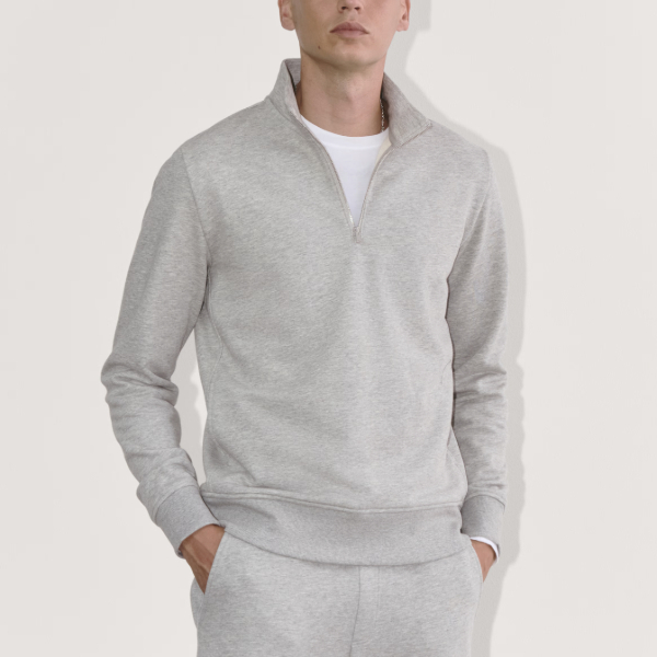 man wearing a quarter zip terry hoodie over sweat pants