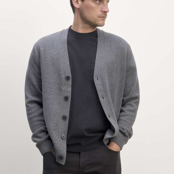 man wearing a classic v neck button front cardigan over a crew neck shirt and chino pants