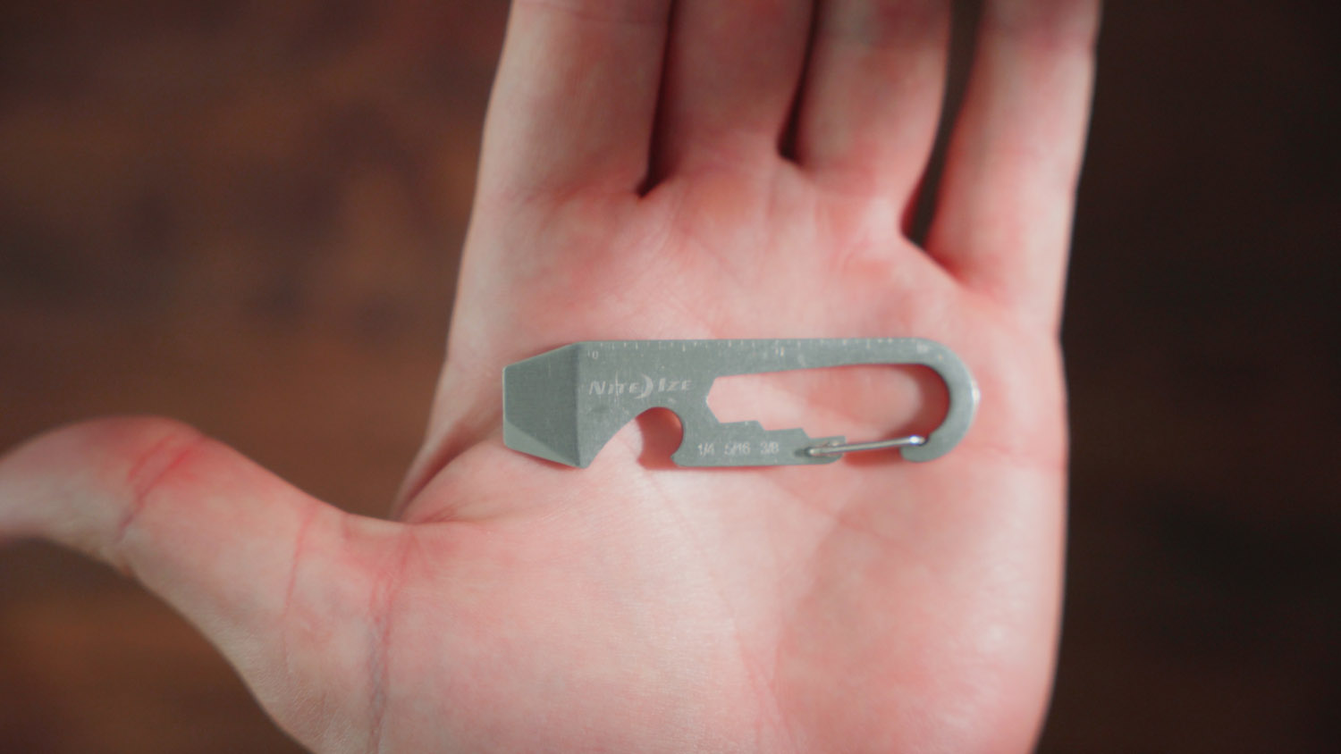 a person showing a closup of a carbiner key clip