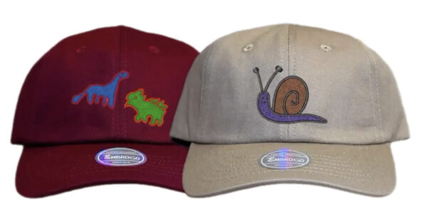 two kids hats with custom embroidered personalized drawings of assorted animals