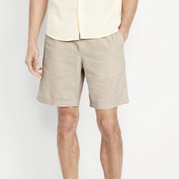 man wearing jogger shorts with a button front shirt