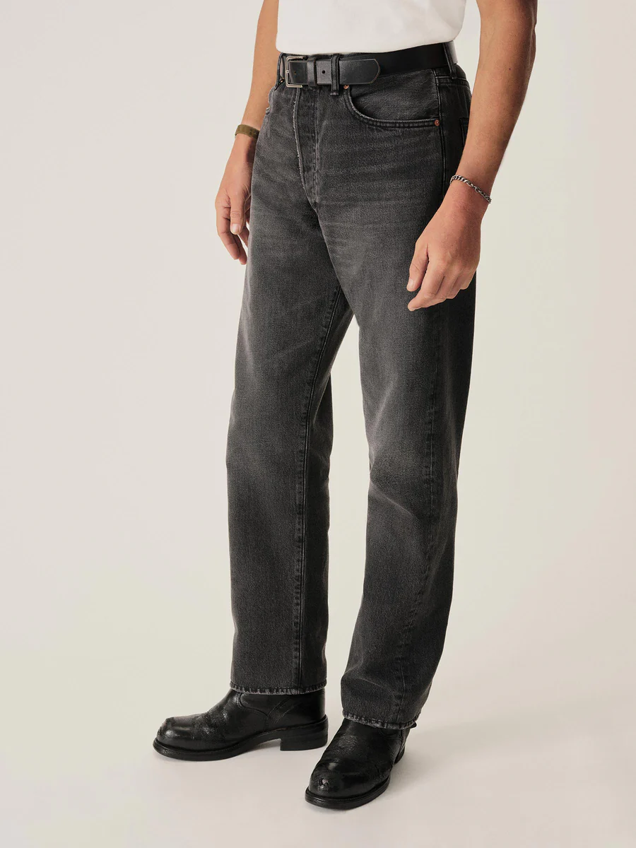 person wearing high rise denim pants with boots