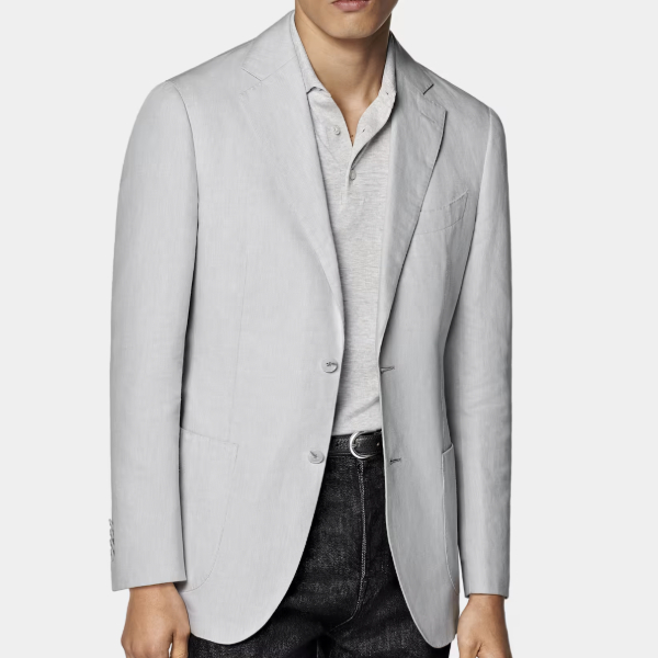man wearing a grey linen suit jacket over a button front shirt