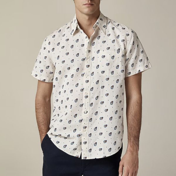 man wearing a short sleeve button front shirt with simple print pattern
