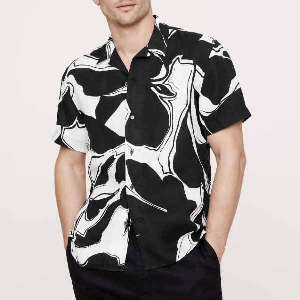 man wearing a short sleeve button front shirt with print pattern