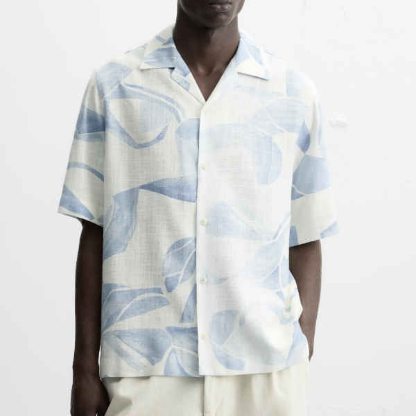 man wearing a short sleeve button front print shirt
