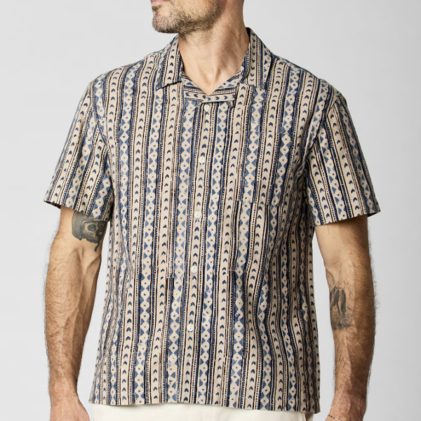 man wearing a printed short sleeve camp collar shirt