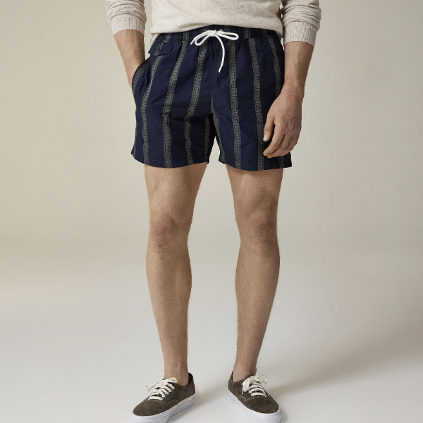 man wearing 6" cotton-nylon blend swim trunk in dobby stripe with slip on shoes