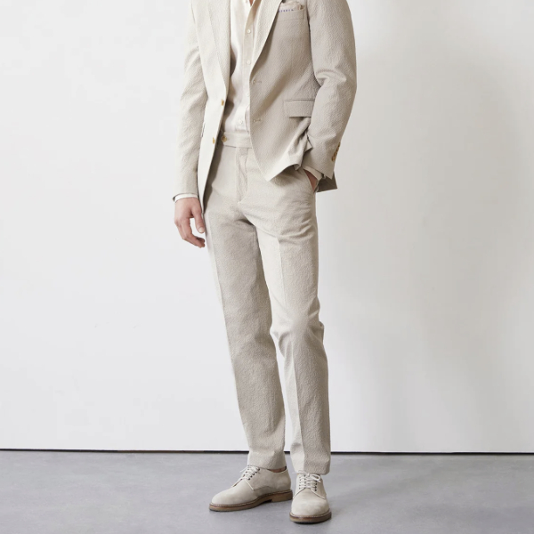 a man wearing seersucker trouser pants