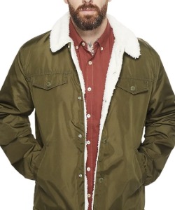 man wearing a trucker style jacket with sherpa lining and collar over a button from collared shirt