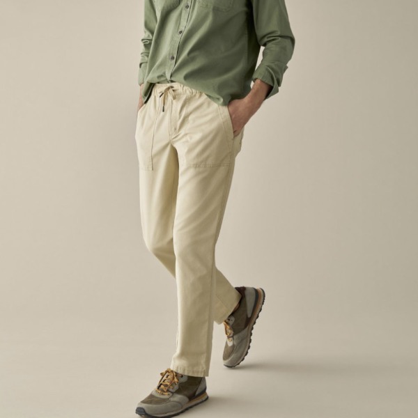 man wearing straight leg pant with drawstring waist, casual button front shirt, and slip on shoes