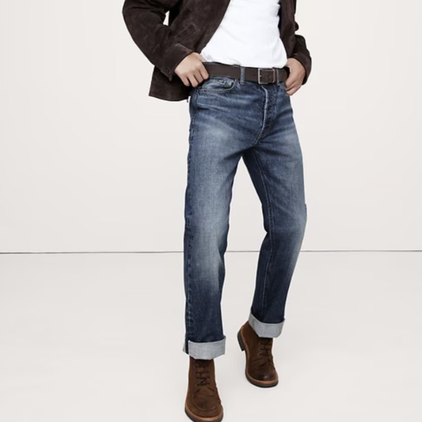 man wearing a straight fit selvedge denim jean with a jacket and boots