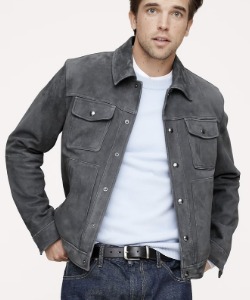 man wearing a suede trucker style jacket and a crew neck shirt