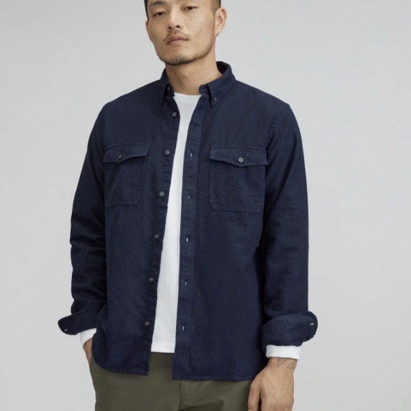 man wearing a brushed flannel shirt over a crew neck shirt