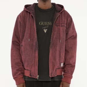 man wearing a denim zip front hooded jacket over a Guess graphic t-shirt