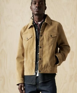 man wearing a vintage faux cow suede trucker style jacket