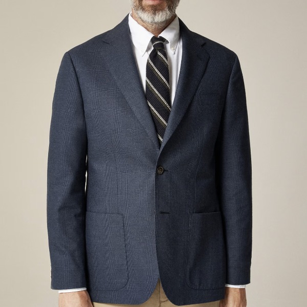 man wearing a navy blazer with a button front shirt and striped tie