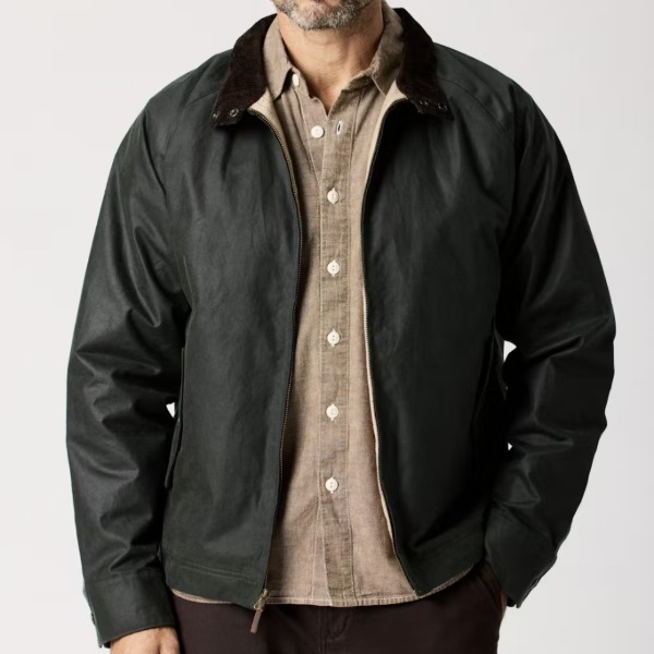 man wearing a waxed harrington style jacket with a button front shirt