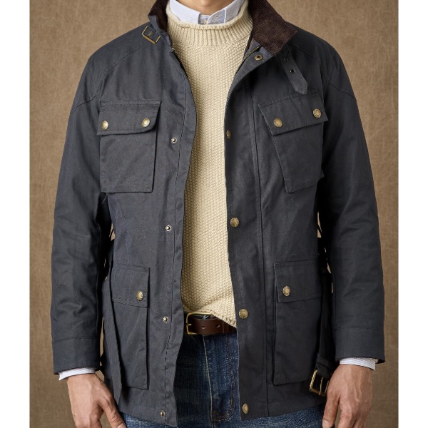 man wearing a waxed cotton touring jacket with a sweater and collared shirt