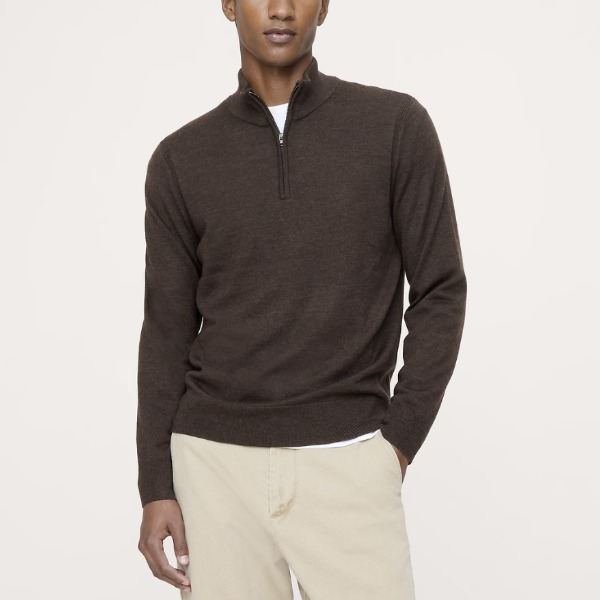 man wearing a quarter zip sweater and pants