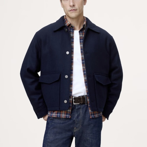 man wearing a wool blend utility jacket over a shirt and pants