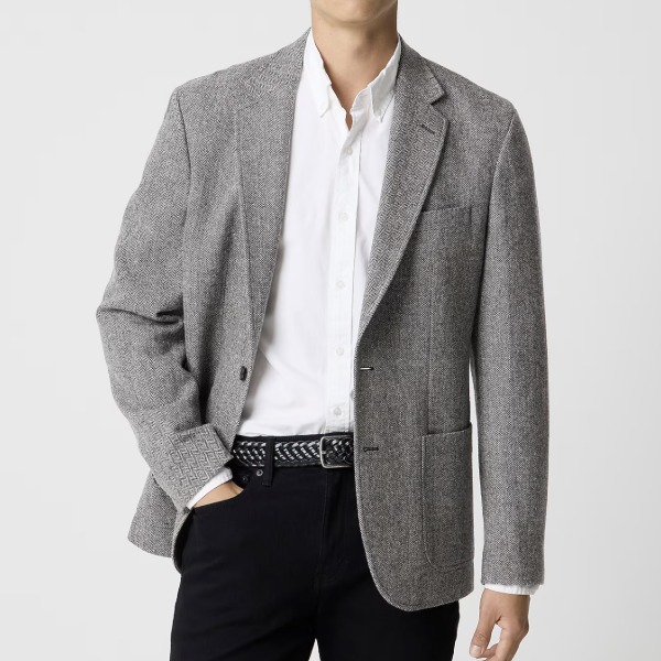 man wearing a Wool-blend herringbone blazer over a dress shirt and pants