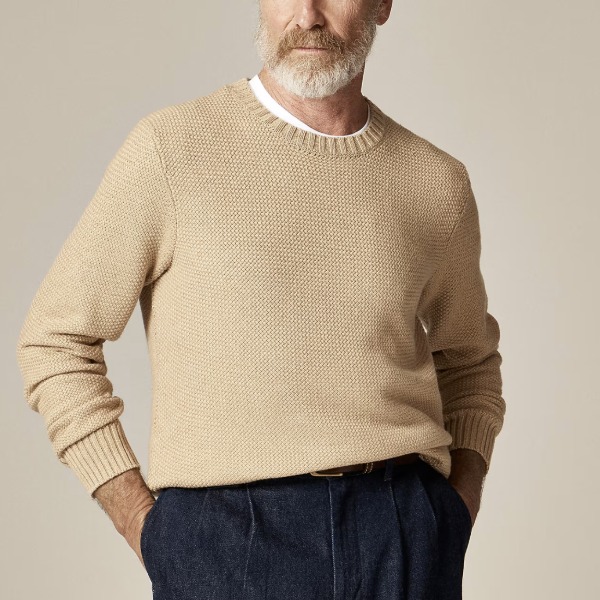 man wearing a basket stitch crew neck sweater with pants