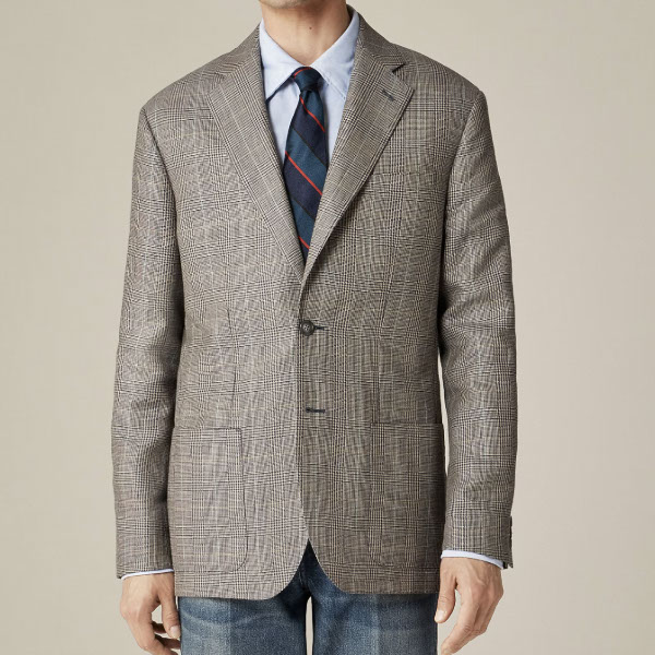 man wearing an English wool blend linen blazer over a shirt and tie