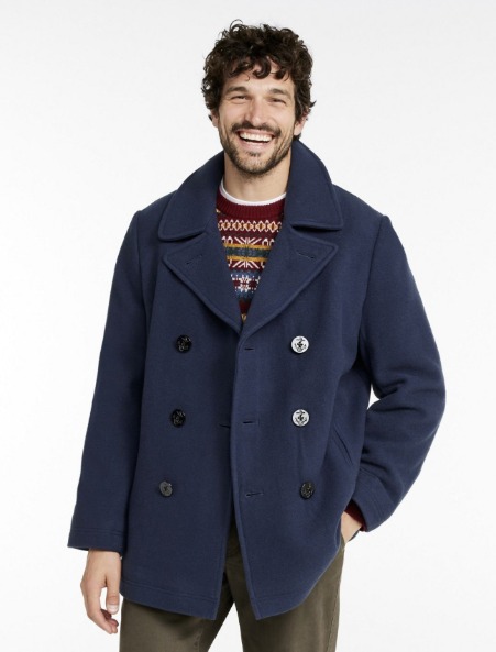 man wearing a wool peacoat over a striped shirt