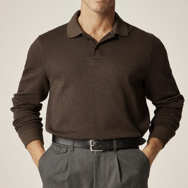 Man wearing a long sleeved polo shirt tucked into pants