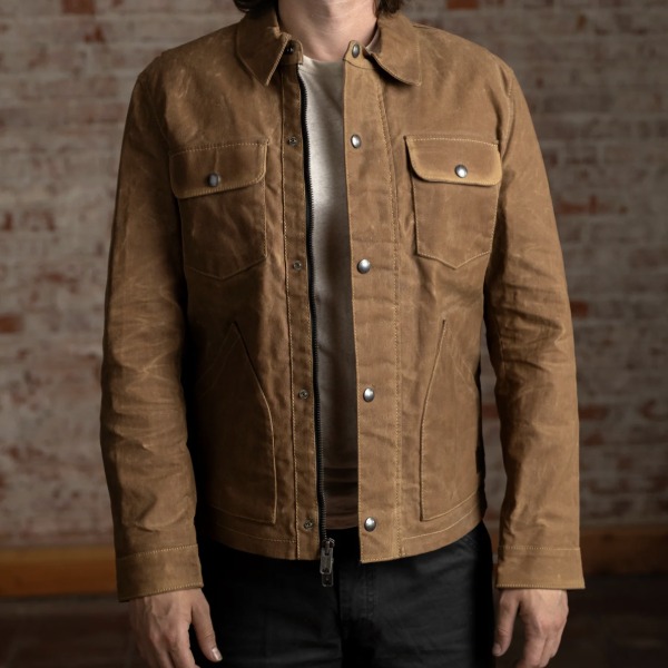 man wearing a waxed canvas cruiser style jacket