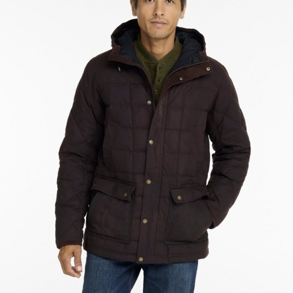 man wearing a quilted waxed hooded jacket