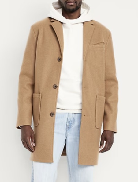 Untitled-4 man wearing a brushed top coat over a shirt and denim pants