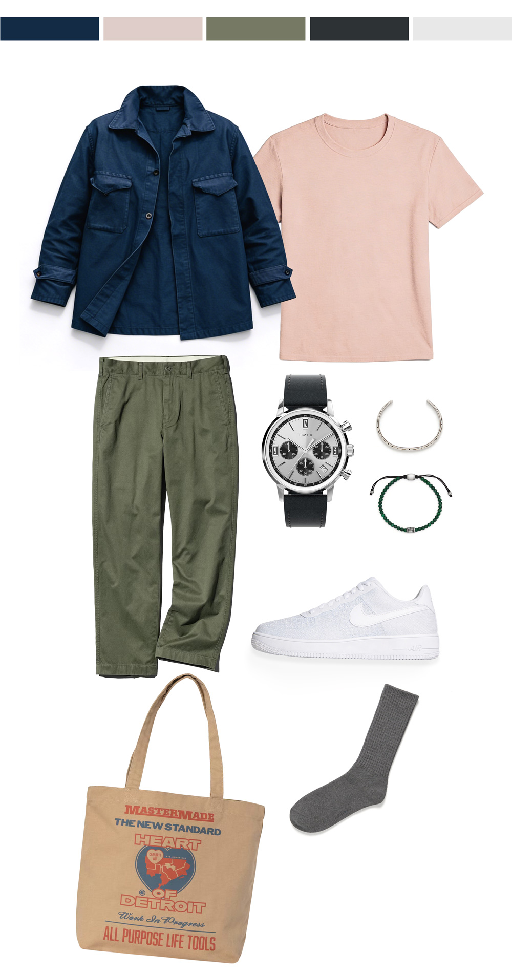 Flat lay of a men’s spring outfit on a light gray background, featuring a navy overshirt with flap chest pockets layered over a pale pink crew-neck T-shirt, olive green pants, a silver watch with a black leather strap, a slim silver cuff bracelet, a green beaded bracelet, white low-top sneakers, a tan graphic tote bag, and a single gray sock. Five color swatches across the top show the palette: navy, blush pink, olive green, charcoal, and light gray.
