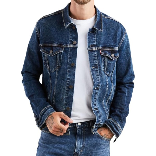 image of a man wearing a denim levis trucker style jacket over a crew neck shirt and denim jeans